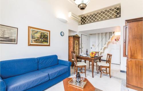 a living room with a blue couch and a table at Girasole in San Michele di Pagana