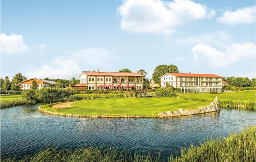 a rendering of a golf course with a lake and buildings at Fewo Wasserburg Turow in Kaschow