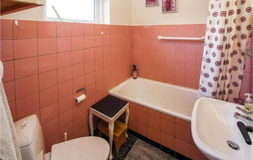 uma casa de banho com uma banheira, um WC e um lavatório. em Amazing Home In Sams With Kitchen em Nordby