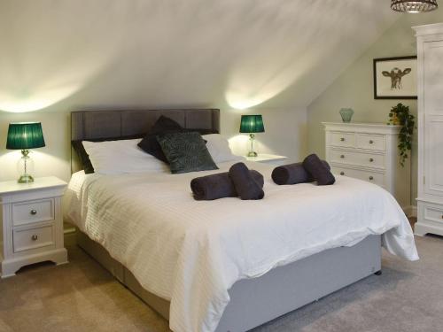 a bedroom with a large bed with two night stands at Ty Ni in Dyffryn