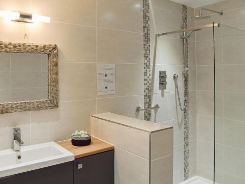 a bathroom with a shower and a sink and a shower at Ty Ni in Dyffryn
