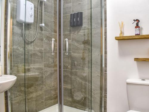 a shower with a glass door in a bathroom at Gwynn House in Camborne