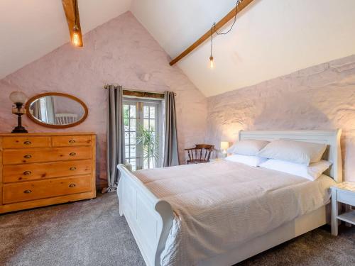 a bedroom with a large white bed and a mirror at Sitch Farm in Matlock Bank