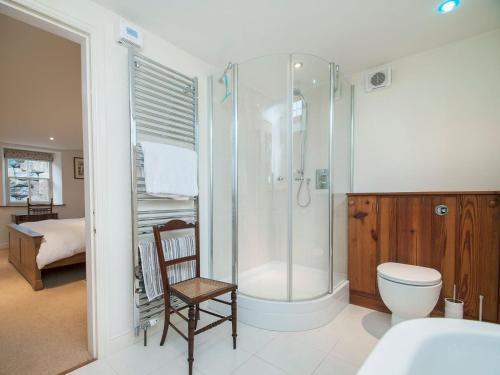 a bathroom with a shower and a toilet and a sink at The Old Chapel in Gammersgill