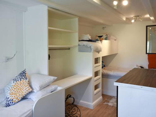 a small room with bunk beds and a counter at Ramblers Rest - Uk33474 in Nenthead