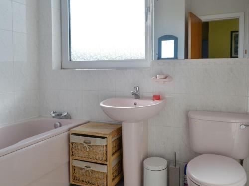 a bathroom with a sink and a toilet and a bath tub at Bel-mar in Whithorn