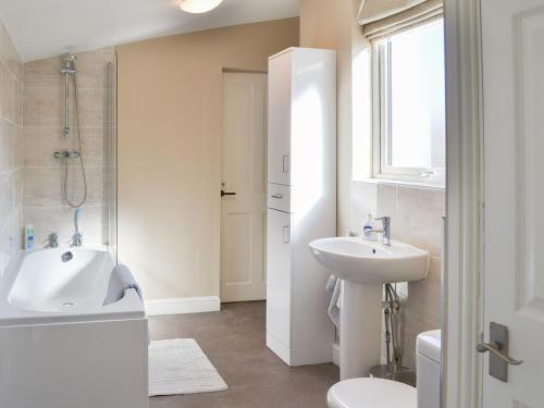ein Bad mit einem Waschbecken, einer Dusche und einem WC in der Unterkunft Loweys Harbour Cottage in Bridlington