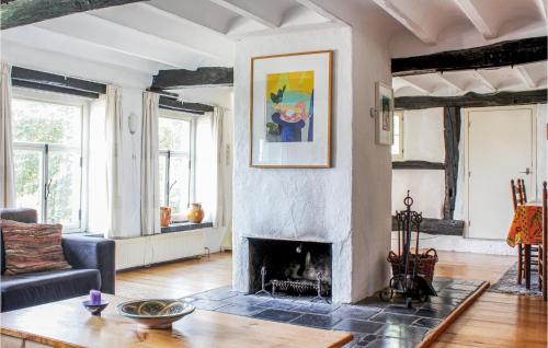 a living room with a fireplace and a couch at Stunning Home In Gulpen With Wifi in Gulpen