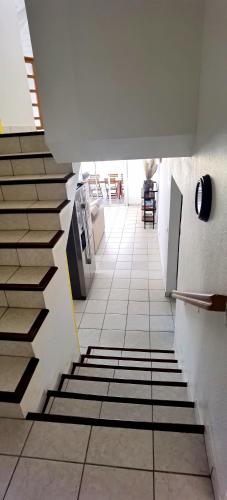 a hallway with a staircase in a building at DV REAL PHILOXENIA Villa in Oyster Pond