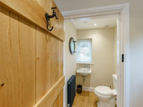 a bathroom with a toilet and a sink at Tyr Ywen Cottage in Abergavenny