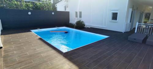 a swimming pool in the middle of a patio at DV REAL PHILOXENIA Villa in Oyster Pond