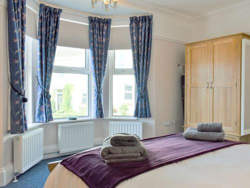 a bedroom with a large bed with towels on it at Upper Deck in Turnchapel