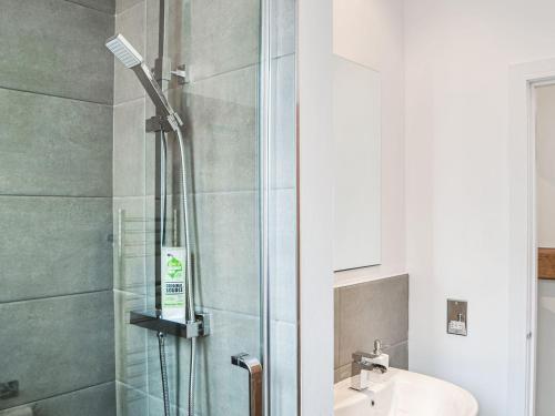 a bathroom with a shower and a sink at Chapel Mouse Cottage in Cockermouth