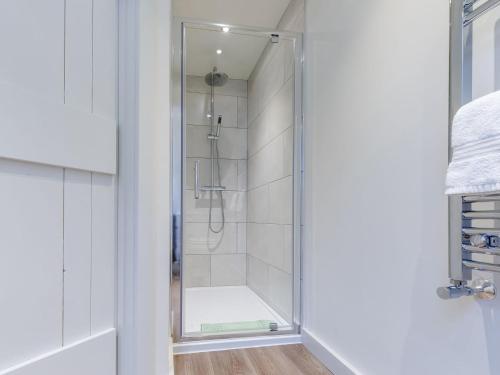 a shower in a bathroom with a glass door at Willow Cottage At Naze Farm-uk32760 in Chinley