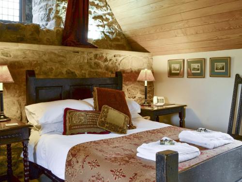 a bedroom with a bed with two towels on it at Braidwood Castle - Uk10672 in Braidwood