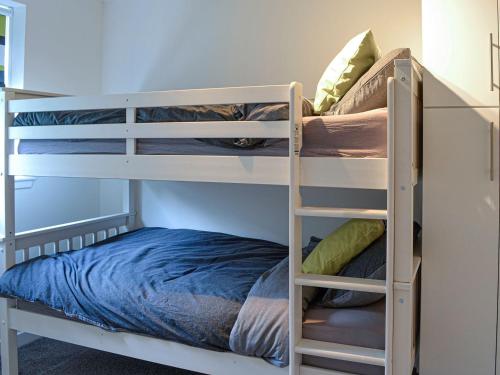 two bunk beds in a room with a bed at The Tranquil Orchard - Woodpecker-uk31339 in Mouswald