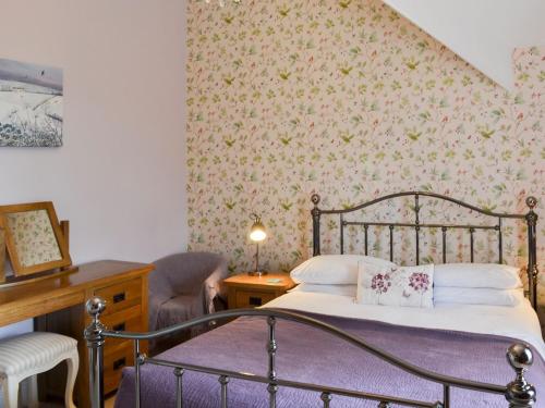 a bedroom with a bed and a chair and a desk at Forge Villa in Ebberston