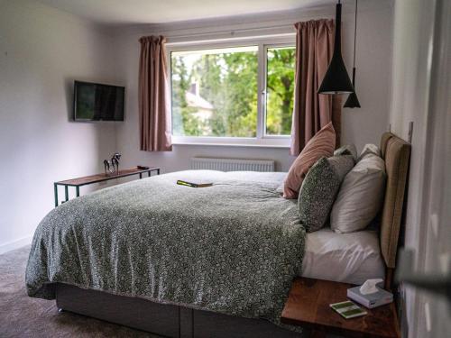 a bedroom with a bed and a window at Moorlands in Chilcompton