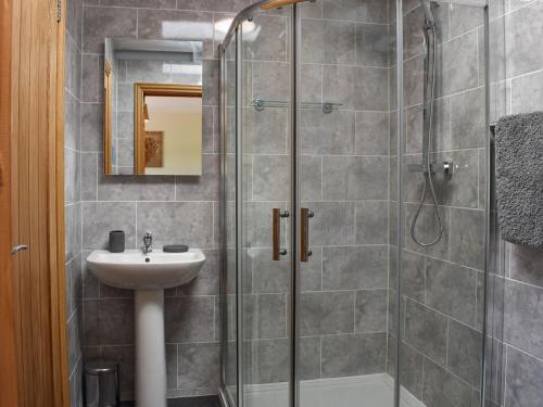 a bathroom with a shower and a sink at The Stables At Greenview in Winsham