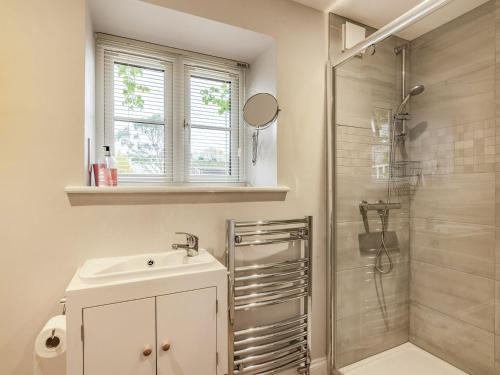 a bathroom with a sink and a shower at The Stables At Wells-in-the-field Farm in Whitchurch
