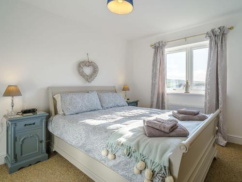 a bedroom with a bed and a window at Seacote Gardens in St Bees