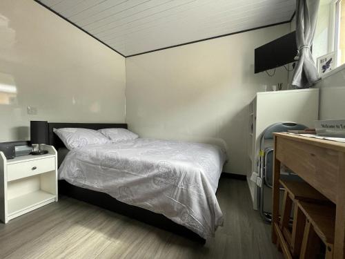 a small bedroom with a bed and a sink at Uist - Uk34049 in Stornoway