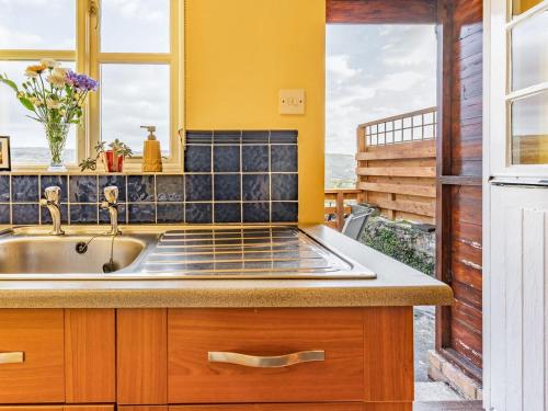 a kitchen with a sink and a window at Number 4 in Llandeilo