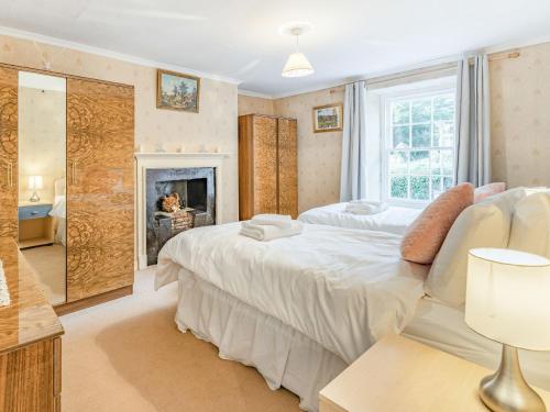 a bedroom with a large bed and a fireplace at Number 4 in Llandeilo