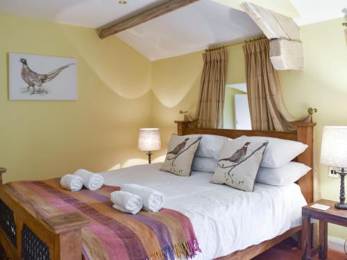 a bedroom with a bed with towels on it at Thorneymire Cottage in Appersett