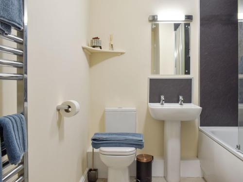 a bathroom with a sink and a toilet and a mirror at Five Dorchester Drive - Uk32043 in Inglewhite
