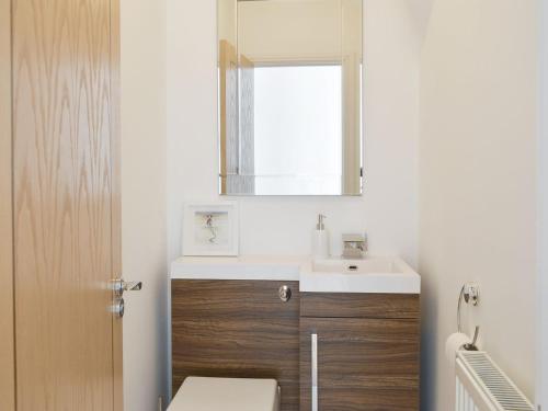 a bathroom with a sink and a mirror at Old Parish Hall in Ramsgate