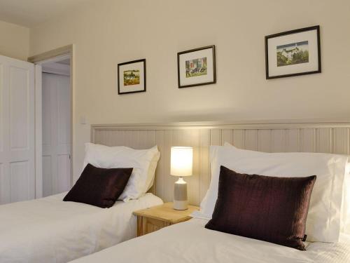 two beds sitting next to each other in a bedroom at Riverholme in Bassenthwaite