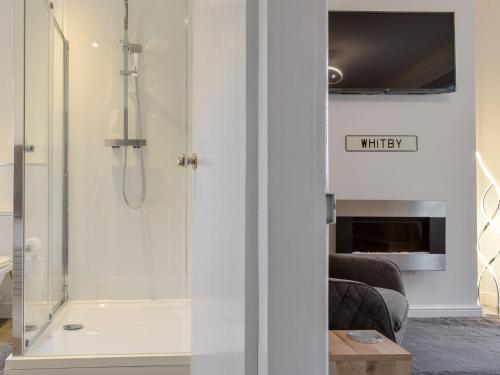 a bathroom with a shower with a glass door at Hidden Gem in Willingham