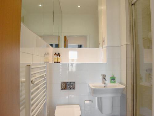 a white bathroom with a sink and a toilet at Atlantic View in Westward Ho