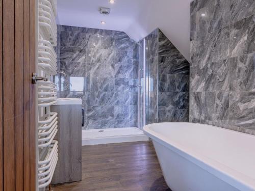 a bathroom with a large tub and a shower at Olive Lodge in Melbourne