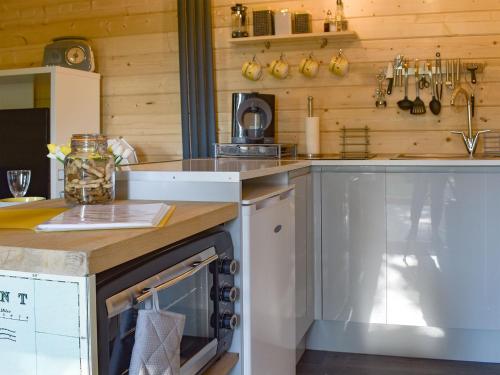 a kitchen with a counter and a dishwasher at Poppy Lodge in Minster