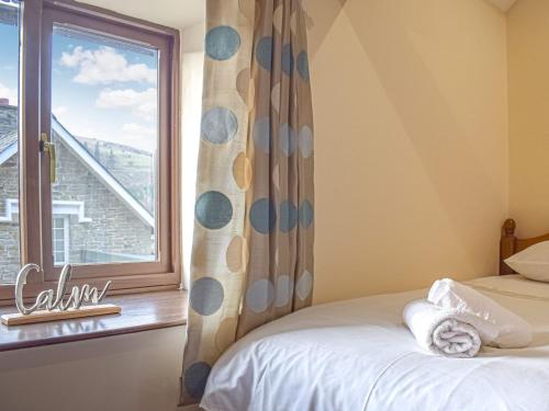 a bedroom with a bed and a window with a view at Border View in Kington