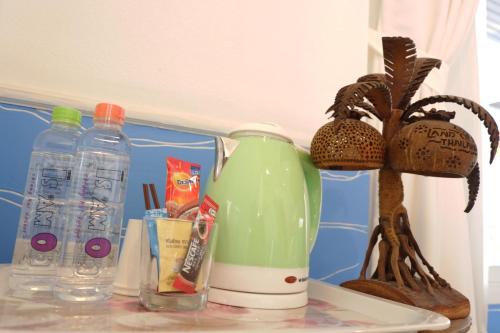 a shelf with a drink bottle and other items on it at Is Am O Chiang Mai Resort in San Sai