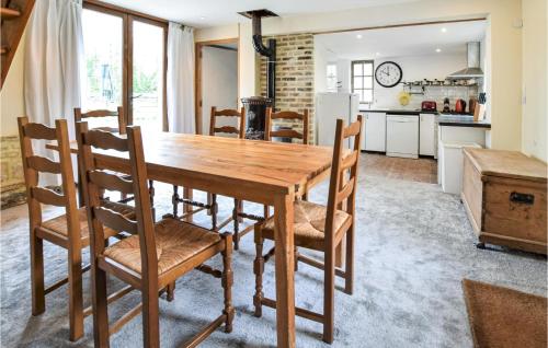 a kitchen and dining room with a wooden table and chairs at Awesome Home In St Pierre En Auge in Vieux-Pont-En-Auge