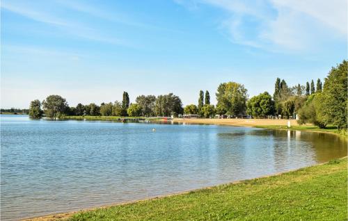 a large lake in a park with trees and grass at Awesome Home In St Pierre En Auge in Vieux-Pont-En-Auge