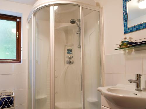 a bathroom with a shower and a sink at Quarry Cottage in Highpeak Junction