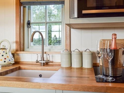 a kitchen with a sink and a counter top with a sink at Grace in Braunston