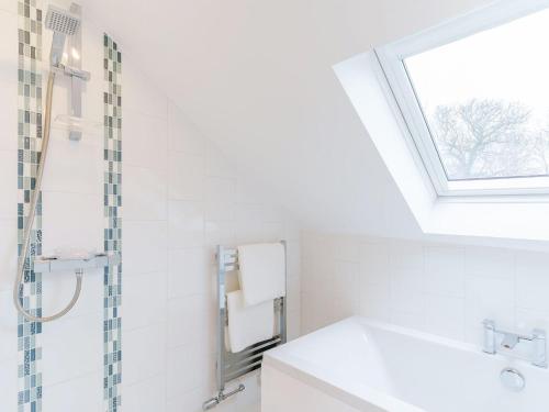 a bathroom with a sink and a skylight at Ty Arth - Uk31652 in New Quay