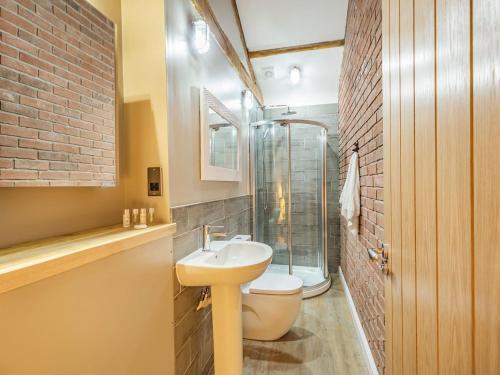a bathroom with a sink and a glass shower at The Barn Owl - Uk36217 in Bowness-on-Solway