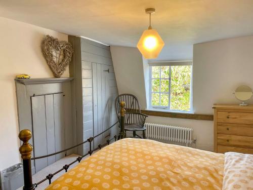 a bedroom with a bed and a window and a chair at Oasis in Bradwell on Sea