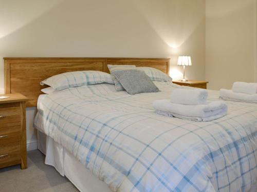 a bedroom with a large bed with towels on it at Croft Cottage 3 - Uk10589 in Stillington