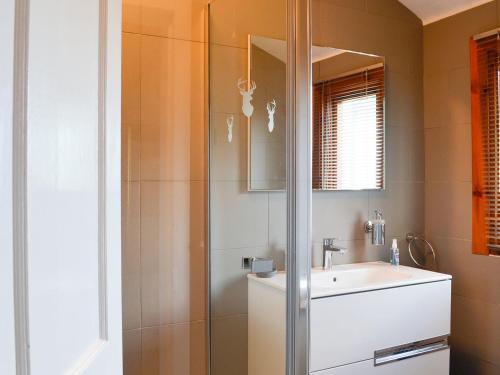 La salle de bains est pourvue d'une douche et d'un lavabo. dans l'établissement Balig Cottage, à Ballantrae
