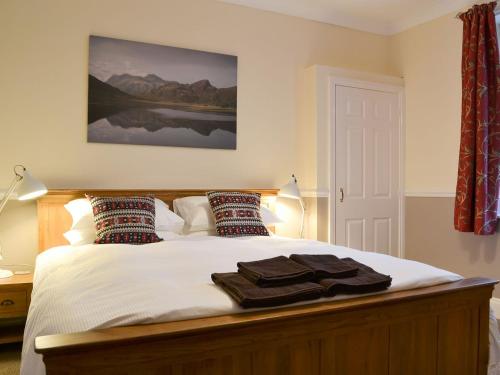 a bedroom with a bed with towels on it at Chartfield in Windermere