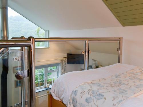 a bedroom with a bed and a window at Woodland Retreat in Washaway