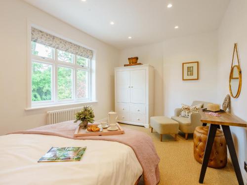 a bedroom with a bed with a tray on it at Inner Lodge in Bolton by Bowland